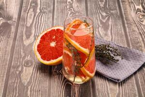 A glass of orange juice with a grapefruit slice photo