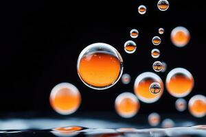 Orange and transparent bubbles floating on dark background with reflections photo
