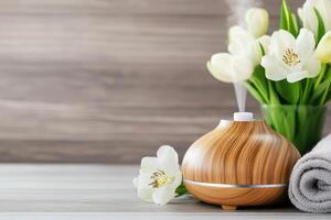 Aroma oil diffuser releasing calming steam into air with spring flowers. .. photo