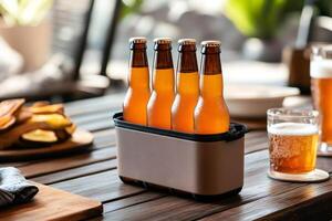 Four cold beer bottles resting in a cooler on a wooden table during a garden party photo