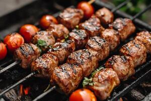 Pork and cherry tomato skewers grilling on barbecue photo