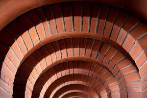 Brick arches creating a tunnel effect in building architecture photo