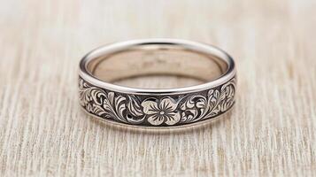 Elegant Hand Engraved Silver Wedding Band with Floral Design A Detailed Close up Shot of a Beautiful Ring photo