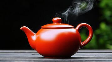 Aromatic Red Teapot Steaming Hot Tea on Wooden Table Outdoors photo