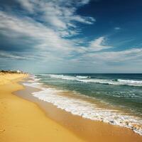 A beach with a blue sky and white clouds photo