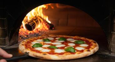A pizza is being cooked in a wood burning oven photo