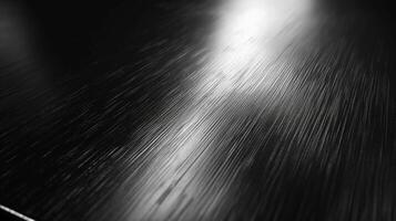 Close-up view of a sleek, polished black surface with subtle texture and reflections. photo