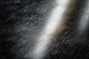 Close-up of a textured black surface with subtle metallic reflections. photo