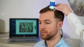 Man with dandruff undergoing scalp examination at trichologist video