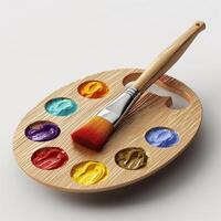 A wooden artist palette with vibrant paints and a brush, ideal for creative expression. photo