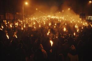A large crowd of people holds torches, illuminating the night with flickering flames, creating a dramatic and intense atmosphere. photo