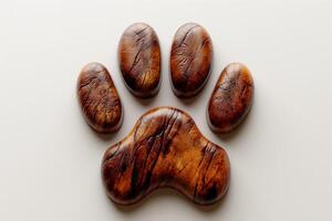 An artistic wooden paw print sculpture on a light background, showcasing intricate textures and warm tones. photo