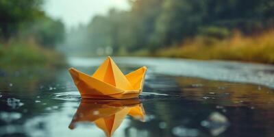 A vibrant yellow paper boat floats gently on a serene water surface, surrounded by lush greenery and soft morning light. photo