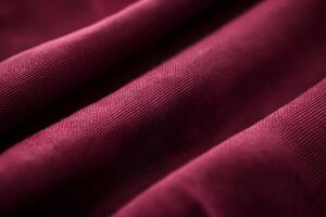 A close-up of rich burgundy fabric showcasing soft textures and intricate woven patterns. photo
