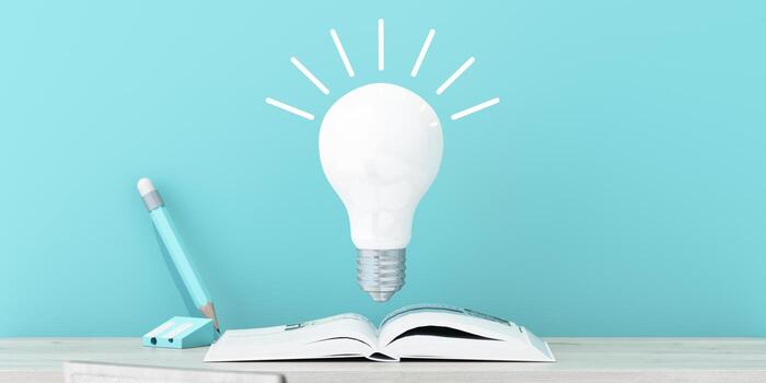 A floating glowing bulb above an open book with a pencil beside, symbolizing knowledge and creative thinking in a minimal study setup. 3d rendering. photo