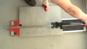 A machine for cutting large ceramic tiles into smaller tiles with precise dimensions. A jack-of-all-trades who uses a machine when working with tiles video