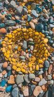 A colorful circle of rocks and pebbles on the beach photo