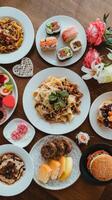 A table with many plates of food and flowers photo