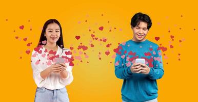 A couple celebrates St. Valentine's Day, smiling and exchanging affectionate messages on their smartphones. Their joy is highlighted by heart graphics, creating a festive atmosphere. photo