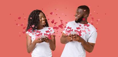 A loving couple engages with each other on Valentine's Day, using their smartphones to send affectionate messages. photo
