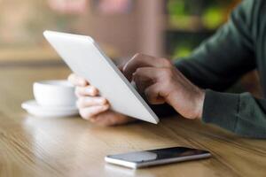 Cropped of entrepreneur using modern digital tablet while spending time at cafe photo