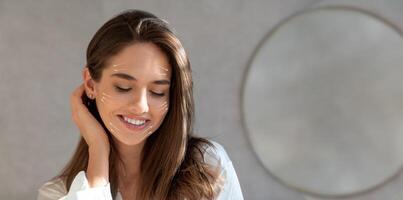 A woman with a joyful expression is indulging in a facial massage in a serene setting. The gentle pampering enhances her skin, promoting anti-aging benefits and relaxation. photo