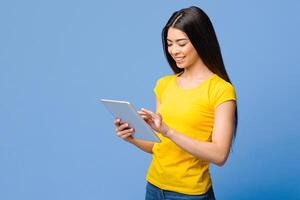Smiling Asian Girl Browsing Social Networks On Digital Tablet Over Purple Background, Enjoying Modern Technologies, Copy Space photo