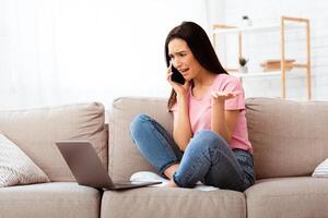 What Happened. Frustrated woman having problem with internet connection, calling customer support hotline photo