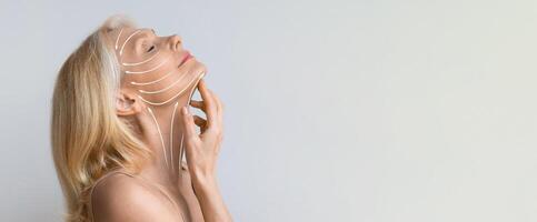 Mature woman experiences a relaxing facial massage aimed at rejuvenation and anti-aging. Soft lines illustrate the massage technique, enhancing her skincare routine in a serene setting, copy space photo