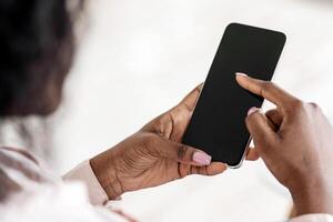Unrecognizable African American Female Browsing Smartphone With Black Screen, Checking New App Or Scrolling Website, Using Modern Gadget With Blank Touchscreen, Mockup Image For Your Design photo