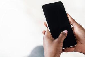 Unrecognizable Black Woman Using Smartphone With Blank Black Screen At Home, Checking New App Or Website, Browsing Internet, Spending Time With Gadget, Mockup Image With Empty Space, Closeup photo