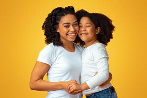 Love Of Mother And Daughter. Happy Black Family Mom And Child Hugging And Smiling At Camera, Posing Over Pink Background With Free Space photo