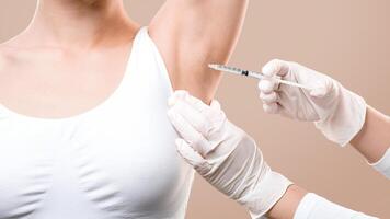 Woman receiving underarm treatment against hyperhidrosis. Armpit injections to prevent excessive sweating, cropped photo