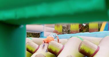 Child Playing on Inflatable Obstacle Course video