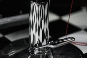 Close-up view of a sleek metal espresso maker with abstract reflections photo