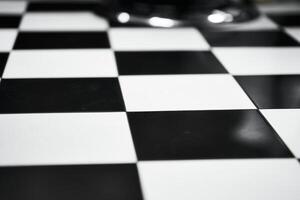 Black and white checkerboard pattern displayed on a polished surface photo