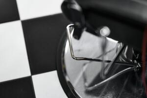 Black and white checkered floor with a barber chair detail in a stylish salon photo