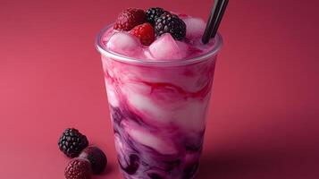 A colorful berry swirl drink filled with ice captures attention with vibrant hues. Fresh raspberries and blackberries accompany the cup, enhancing the refreshing appeal. photo