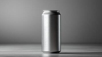 A tall silver can sits vertically on a smooth surface, surrounded by a neutral backdrop. The soft lighting highlights its reflective surface and minimalist design. photo