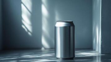 A metallic can stands on a smooth surface, its polished surface reflecting light in an aesthetically pleasing manner. Sunlight streams through a nearby window, creating shadow patterns. photo