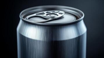 A shiny metallic beverage can is shown closely, highlighting the pop top and smooth surface under soft lighting, creating a sleek appearance. photo