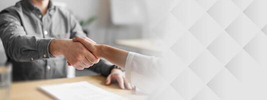 Cropped view of human resources manager shaking hands with successful vacancy applicant at office, closeup. Unrecognizable headhunting specialist welcoming new employee into company team photo