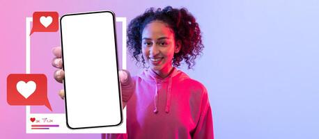 A lively influencer holds a smartphone with a blank screen, ready for social media content creation. The colorful background enhances the excitement of connecting online with followers. photo