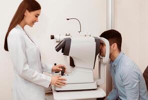 A young man undergoes an eye examination as a professional optometrist operates a testing machine, ensuring accurate assessment of vision health during a routine visit. photo