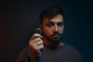 A young man with a bitcoin in his hands. Cryptocurrency. photo