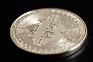 Bitcoin on black background. Cryptocurrency trading. Macro photo