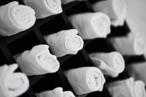 Neatly rolled towels arranged in a decorative display in a spa environment photo