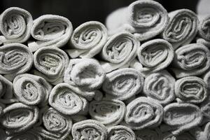Stacked white towels neatly arranged in a bathroom setting photo