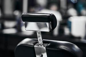 Sleek barbershop chair with polished chrome, perfect for busy hours photo