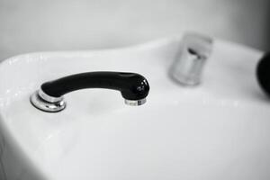 Modern black faucet design in a minimalist bathroom setting photo
